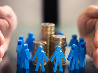 person holding hands around a pile of coins with small blue people in the middle