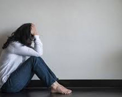 woman sitting and holding her head