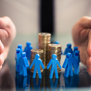 person holding hands around a pile of coins with small blue people in the middle