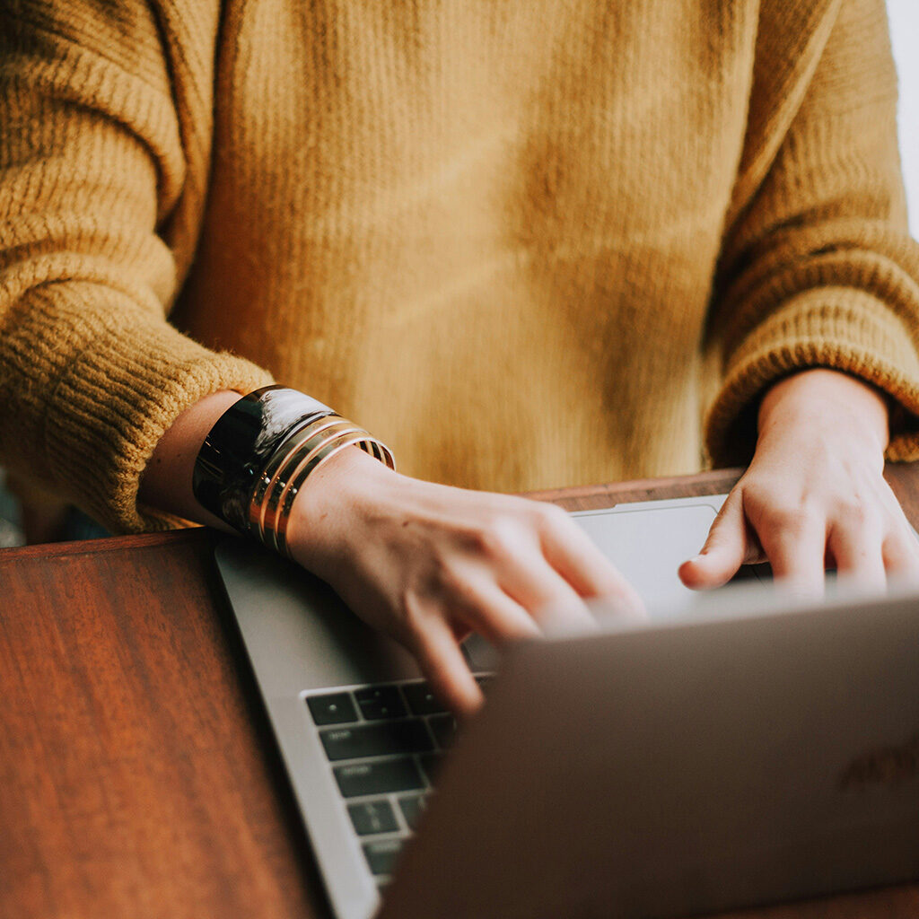 person sitting at table on a laptop